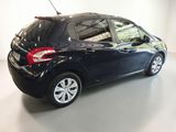 the back end of a black car in a white room
