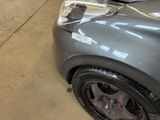a close up of a car that has been painted silver