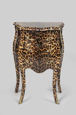 a leopard print bedside table with a drawer on one side and a drawer on the other side
