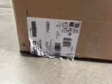 a cardboard box with a sticker on it sitting on the floor