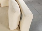 a white couch that has two pillows on top of it