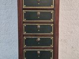 an image of a tall wooden chest of drawers with many drawers