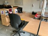 a desk with a chair and a computer on it