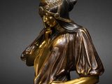 an image of a bronze statue of a woman in a dress