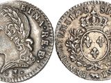 a silver coin with a crown on top of it