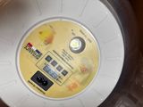 a plastic container with a yellow button on it