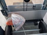 someone is pushing a cart with a bag of food on it