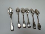 six silver spoons are lined up in a row on a table