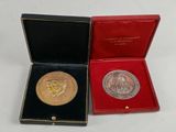 a gold medal in a red box on a white surface