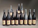 bottles of wine are lined up in a row on a table