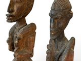 pair of carved wooden figures of a man and a woman