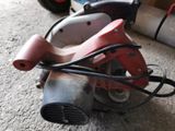 a red and black machine that is sitting on the floor