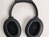 a pair of black headphones on a white surface