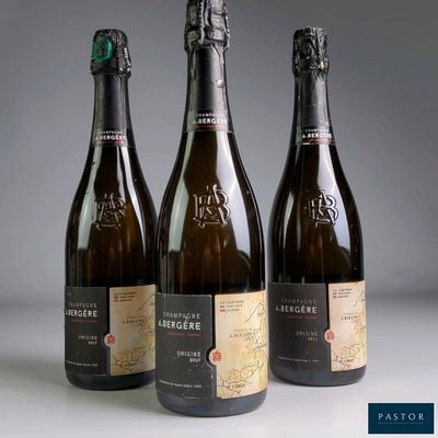 three bottles of wine sitting next to each other on a table