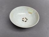a white bowl with a black and white design on it