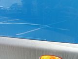 a close up of a car ' s tail light on the side of the road