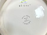 a close up of a black and white plate on a table