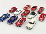 several toy cars are lined up in a row on a white surface
