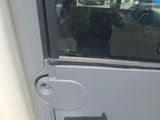 a man taking a picture of himself in the reflection of a car door