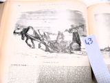 un livre ouvert sur lequel figure le dessin d'un cheval tirant un traîneau