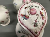 a vase with a lid that has a butterfly design on it