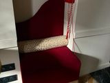 a red chair that has a telephone on it