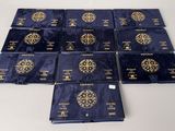six blue and gold books with gold medallions on them