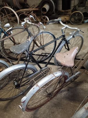 many bicycles that are parked together in a garage