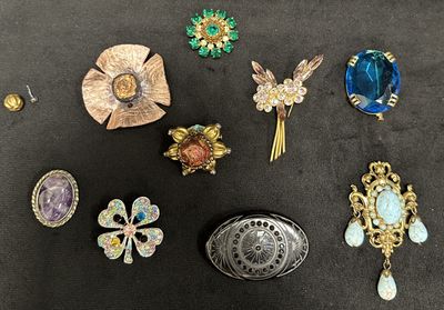 many different types of brooches on the table