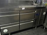 a kitchen with stainless steel appliances in the middle of the room
