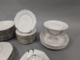 a lot of plates that are stacked together on the table
