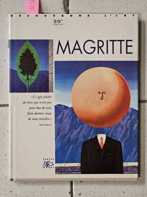 a poster of a man in a suit with an orange on his head
