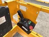 a remote control on the side of a yellow gate