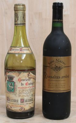 two bottles of wine sitting next to each other on a table