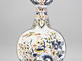 a vase that is sitting on a stand on a table