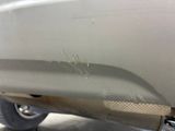 a close up of a car ' s bumper with scratches on it