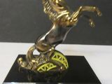 a bronze statue of a horse on a black base