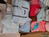 a box full of baby clothes and a stuffed animal