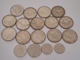 some silver coins sitting on top of a white surface