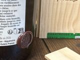 une bouteille de vin posée sur une table à côté d'un bloc de bois