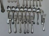 a lot of silver spoons and forks on the table