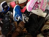 many pairs of shoes that are sitting on the floor
