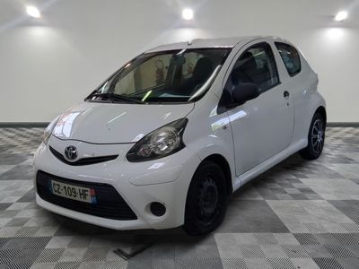 a picture of a small white car parked in a garage