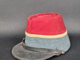 un chapeau rouge et bleu posé sur une surface noire