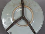 a white plate with a brown ring on it