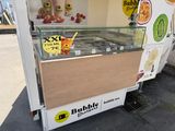 a small ice cream cart with a lot of items on it