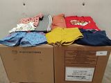 a box full of clothes sitting on top of a pallet