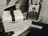 a white box with a black ribbon on it sitting on a desk next to a laptop