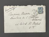 an old envelope with a stamp on it sitting on top of a table