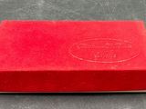 a red box with a silver lid sitting on a table